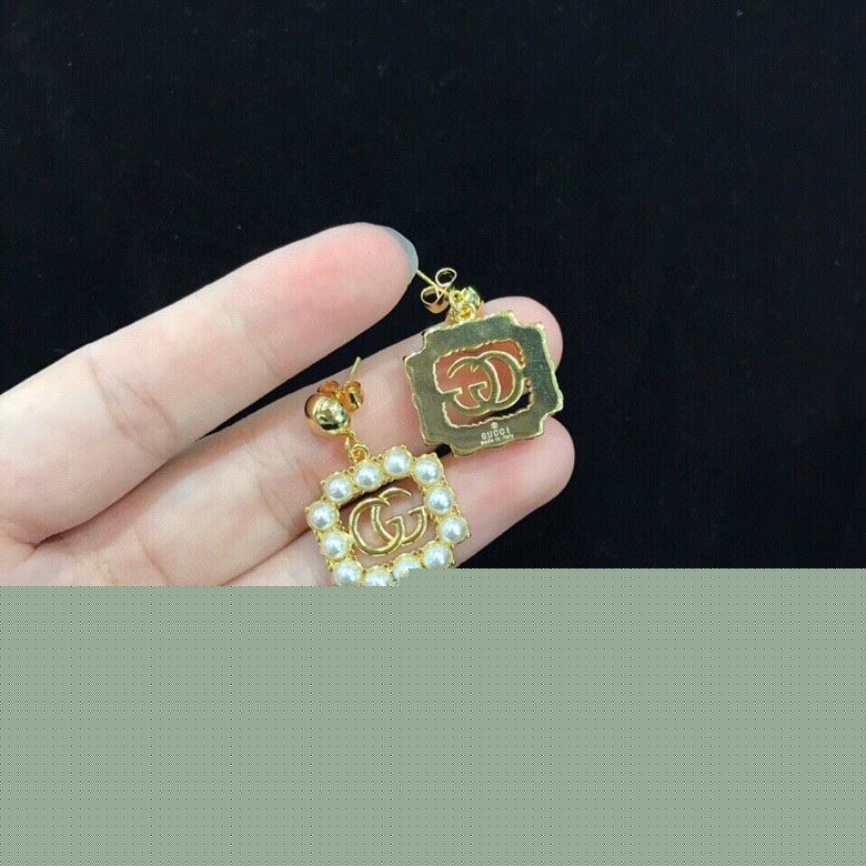 G*u*i earrings